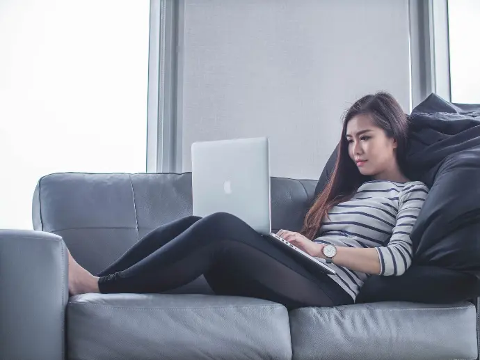 a young real estate agent setting infront of laptop